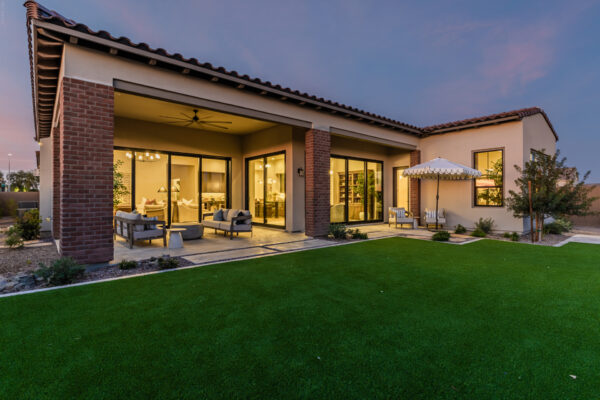 Hazelwood Model Back Yard with dusk light and views into dining and great room